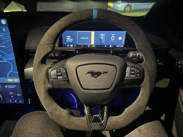 Custom made steering wheel for Mustang Mach-E with leather and Alcantara grips, flat-bottom design, and customizable stitching and accents.