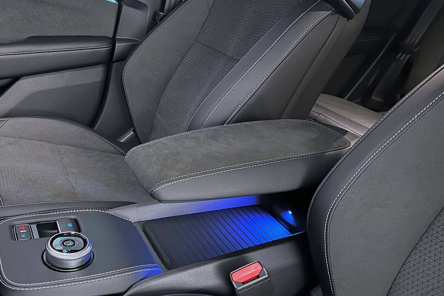 Custom-made armrest with premium Alcantara and leather, enhanced comfort, and personalized stitching.