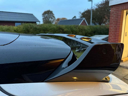 Close-up of a sleek black Rally Wing Spoiler installed on the rear of a Ford Mustang Mach-E enhancing the car's aerodynamic profile and sporty appearance