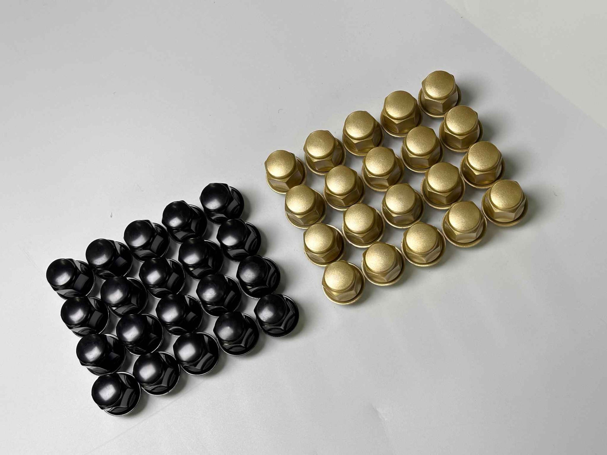 Black and gold forged wheel lug nuts for Mustang Mach-E wheels set on white background