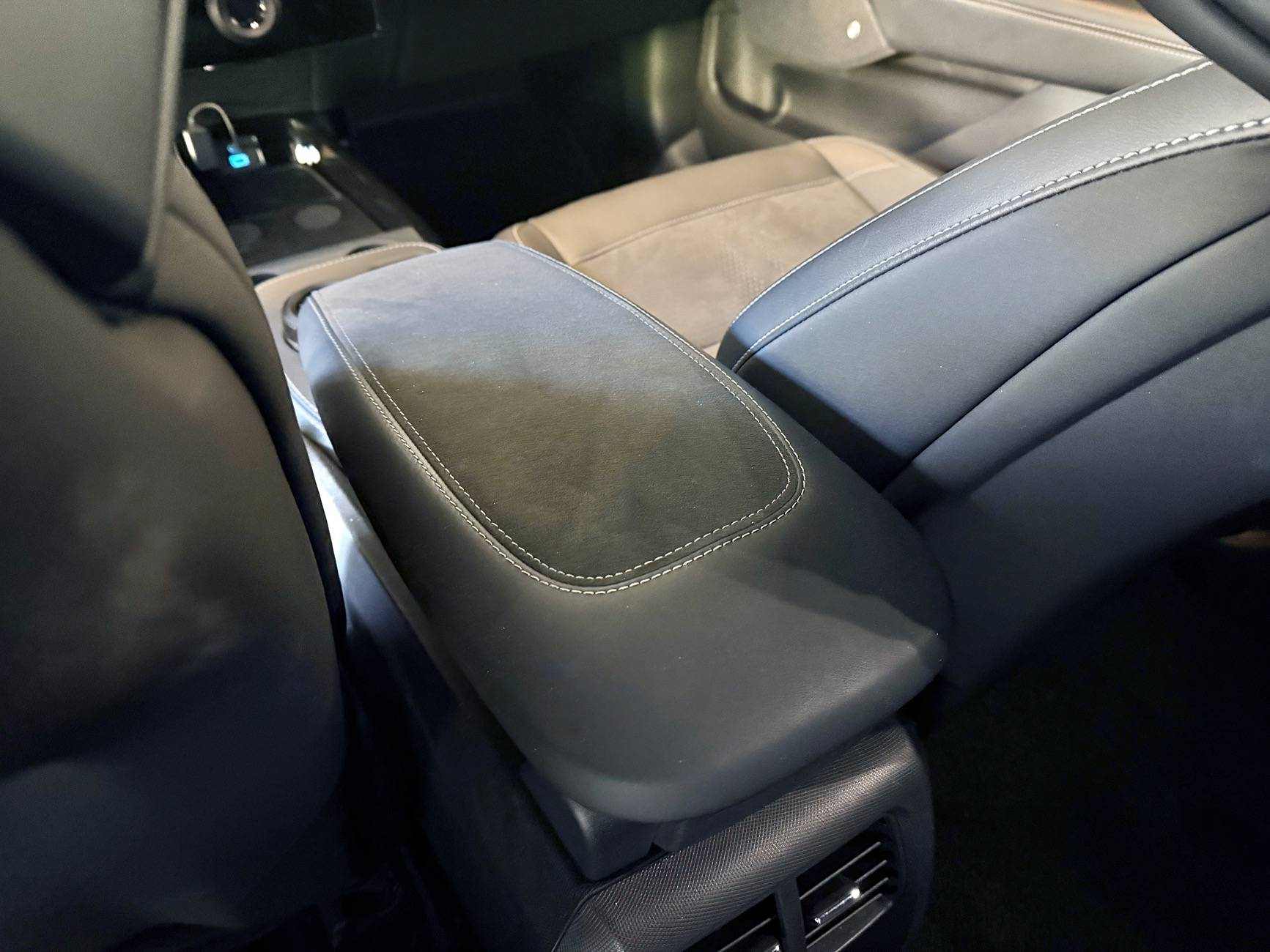 Custom-made armrest with premium Alcantara and leather, enhanced comfort, personalized stitching, and logo customization.