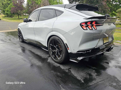 Rear Diffuser for Mustang Mach-E installed on white 2021-2025 model with black carbon fiber finish.
