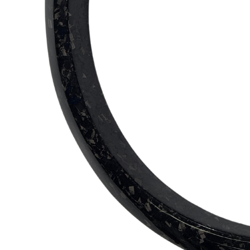 Close-up of a carbon fiber wider fender flare edge with textured finish for vehicle upgrade